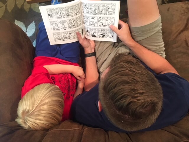 Husband reading aloud to kid