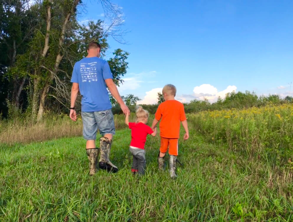 Daddy walking with his two kids, ready for some Family Read Aloud Questions